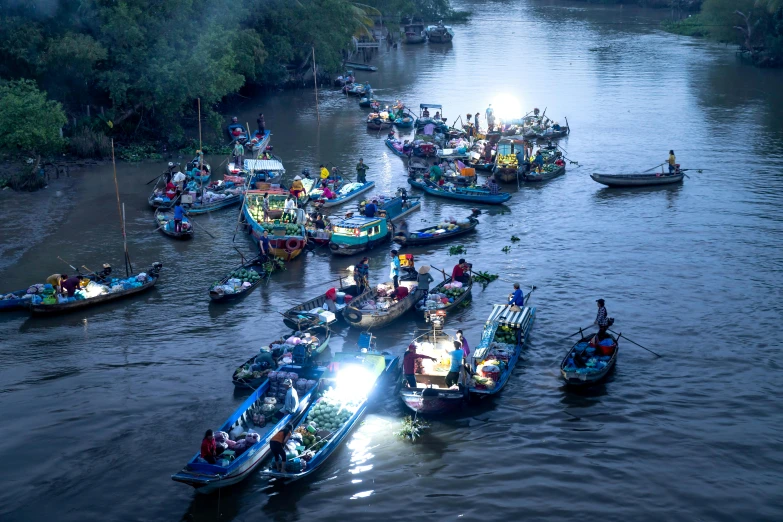 a group of boats floating on top of a river, inspired by Steve McCurry, hurufiyya, light glow, fish seafood markets, slide show, thumbnail