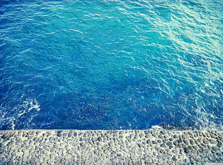 a view of a body of water from above, an album cover, inspired by Elsa Bleda, unsplash, happening, blue, wallpapers, stone ocean, water-cooled