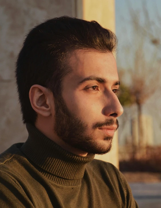 a close up of a person wearing a sweater, by Ismail Acar, proud looking away, nice afternoon lighting, pompadour, kyza saleem