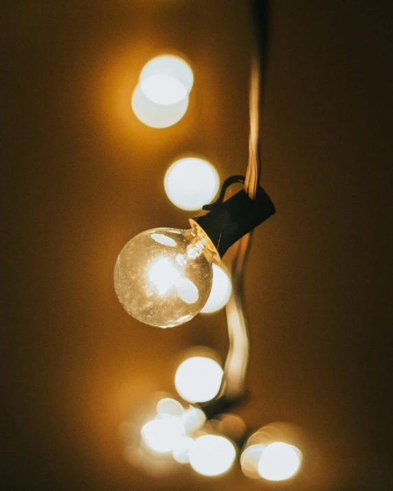 a close up of a string of lights, a cartoon, inspired by Elsa Bleda, trending on pexels, light and space, delightful surroundings, bisexual lighting, soft light from the side, experimental studio light