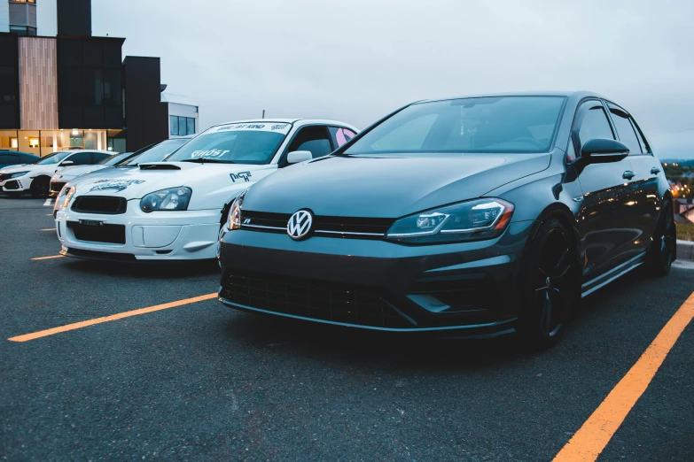 a couple of cars parked next to each other in a parking lot, unsplash, wrx golf, avatar image, festivals, headshot photo