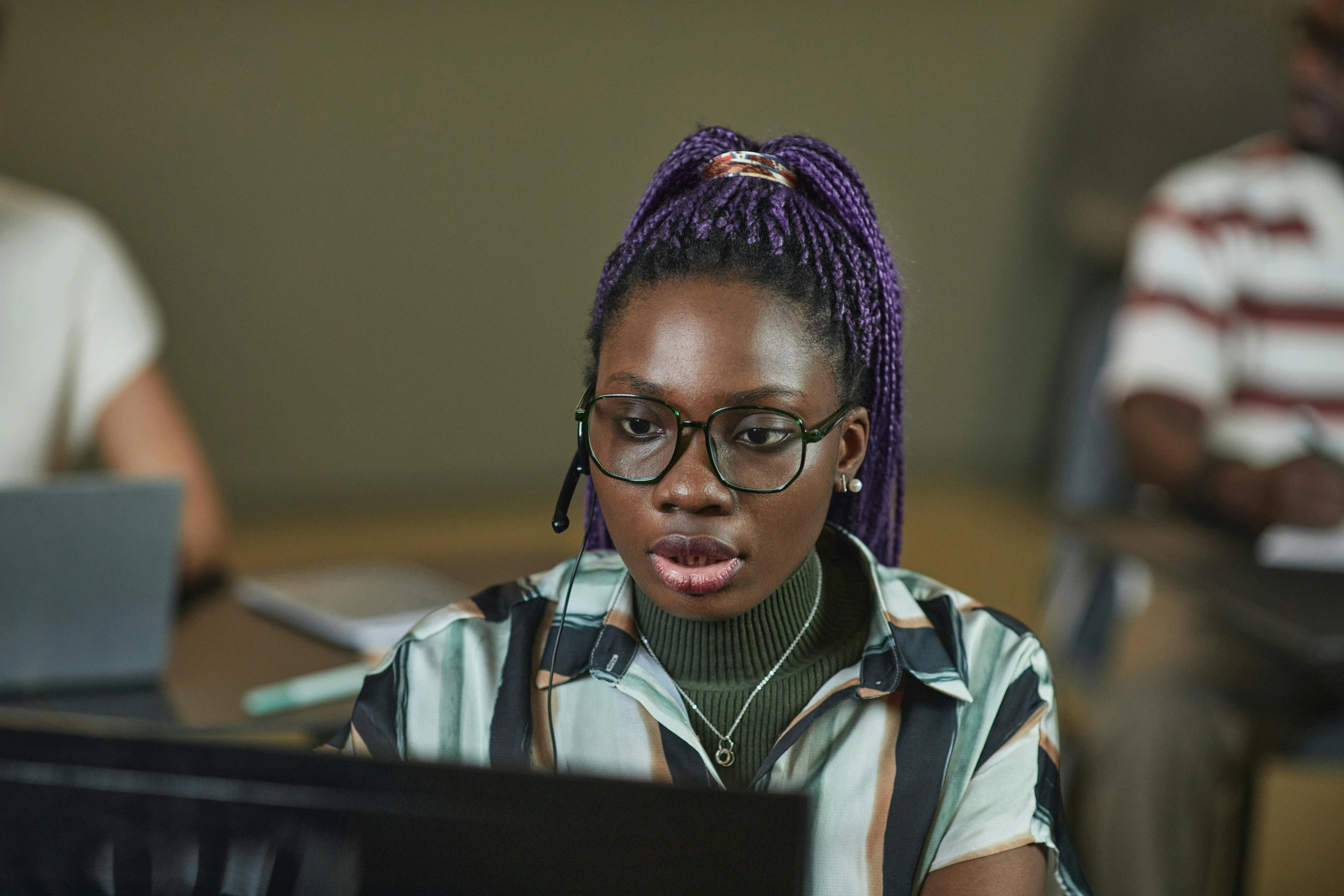 a woman sitting in front of a laptop computer, inspired by Chinwe Chukwuogo-Roy, pexels, still from riverdale, in an call centre office, girl with glasses, foreground