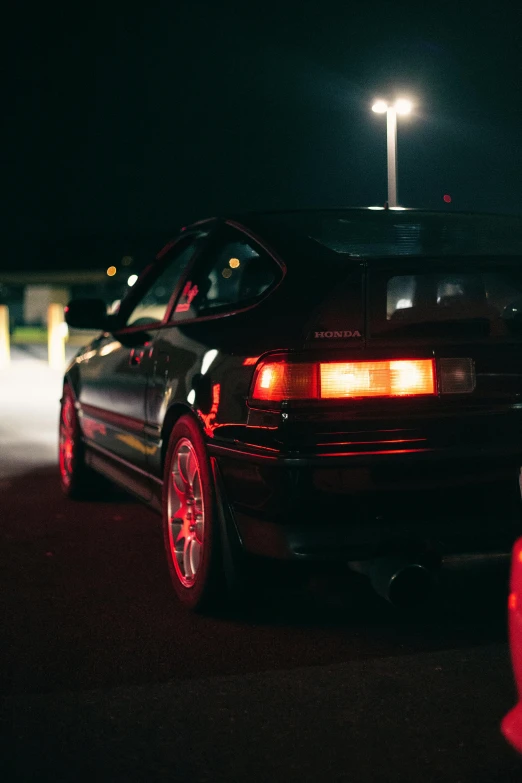 two cars parked in a parking lot at night, pexels contest winner, honda civic, 80s photo, left profile, black car