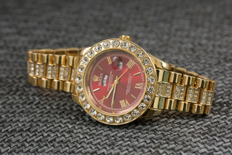 a close up of a watch on a table, instagram, renaissance, wearing red attire, rap bling, 8k, thumbnail