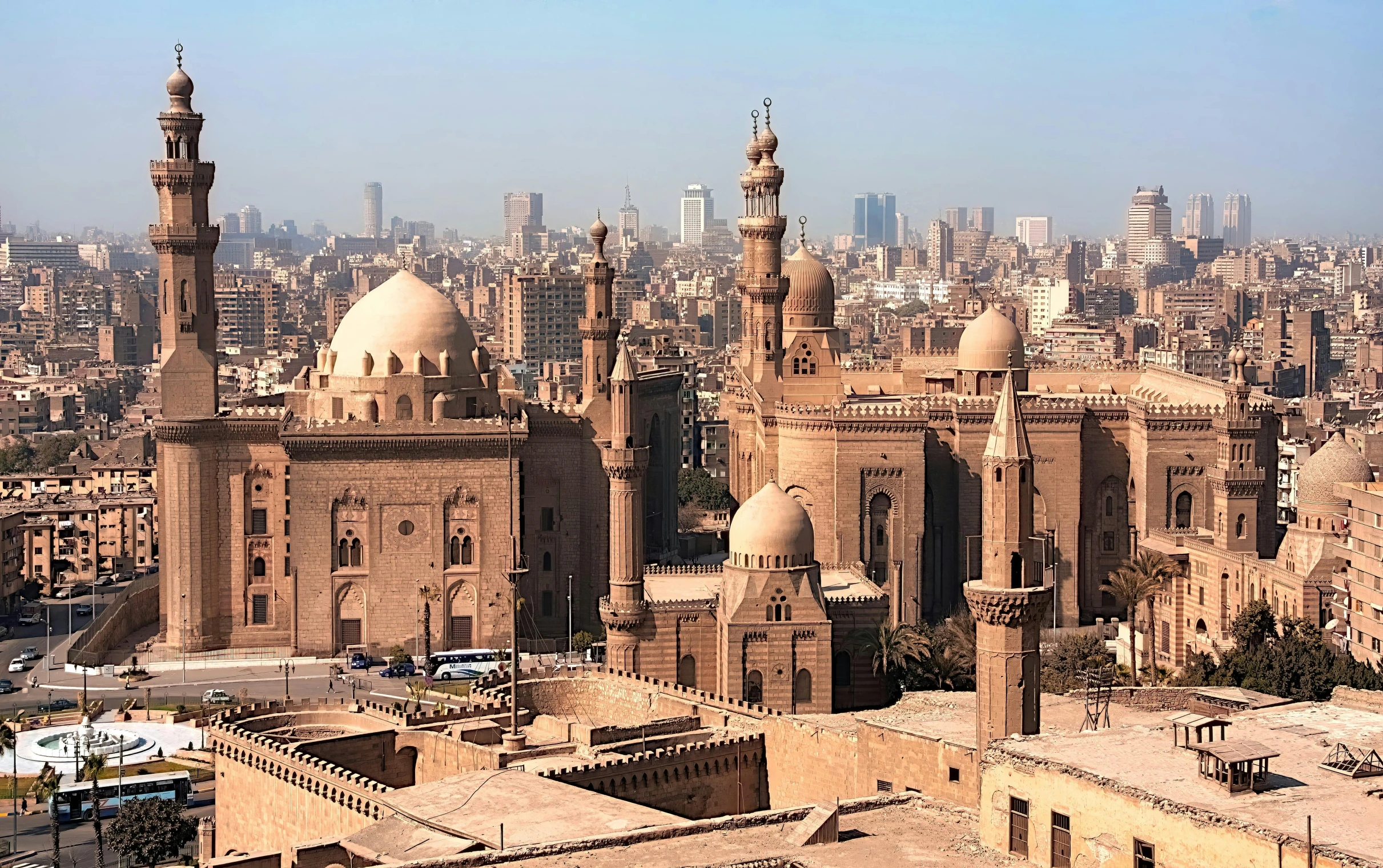 a view of a city from the top of a building, egyptian art, pexels contest winner, hurufiyya, black domes and spires, brown, panoramic, 1999 photograph