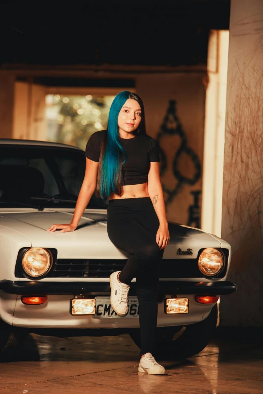 a woman with blue hair sitting on the hood of a car, inspired by Elsa Bleda, pexels contest winner, realism, plain background, standing in front of lowrider, age 2 0, indoor picture