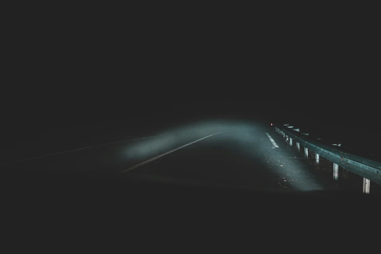 a car driving down a road at night, an album cover, by Adam Marczyński, unsplash contest winner, dark ambient album cover, background image, desolate :: long shot, volumetric light and fog