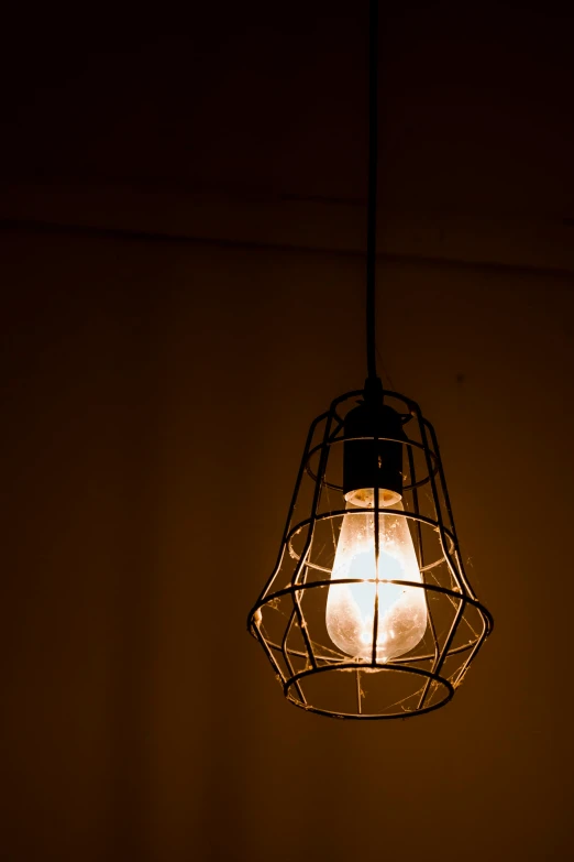 a light bulb hanging from a ceiling in a dark room, nadir lighting, cafe lighting, natural prison light, lumens