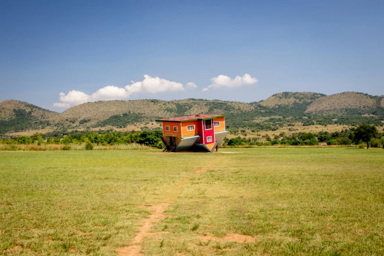 a truck parked in a field with mountains in the background, inspired by Scarlett Hooft Graafland, pexels contest winner, land art, tiny house, unmistakably kenyan, built on a small, portapotty