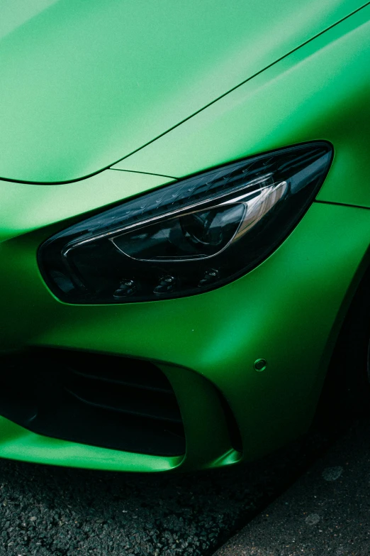 a green sports car parked in a parking lot, trending on pexels, photorealism, skin detail, glowing details!, gradient green black, color ( sony a 7 r iv