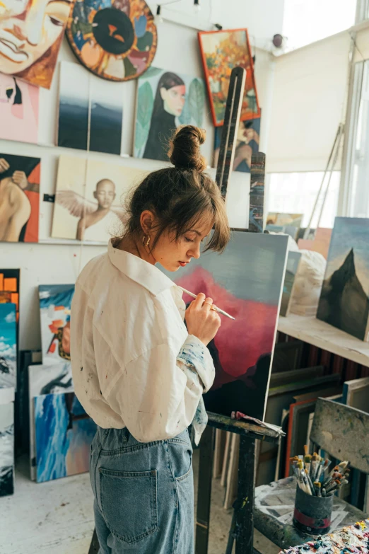 a woman that is standing in front of a painting, trending on pexels, process art, realistic cute girl painting, art stations, profile pic, starving artist wearing overalls