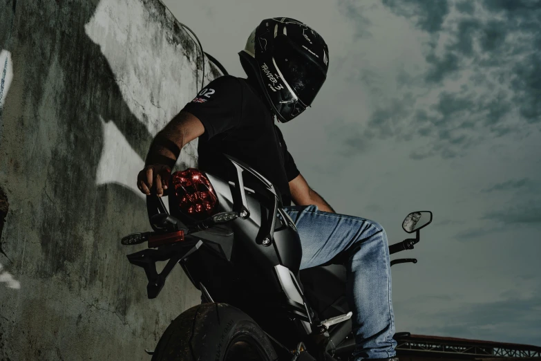 a man in a helmet sitting on a motorcycle, pexels contest winner, ( ( dark skin ) ), techwear clothes, avatar image, low angle shot