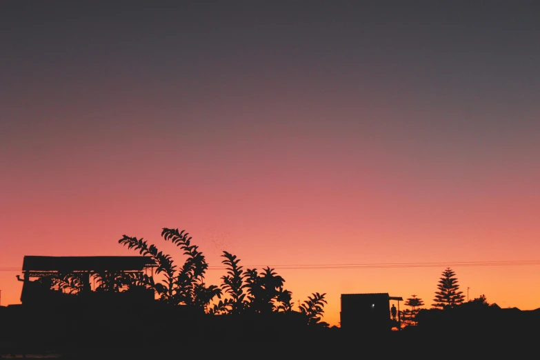 the sky is pink and purple as the sun sets, a picture, unsplash contest winner, minimalism, dark orange night sky, neighborhood, humid evening, silhoutte