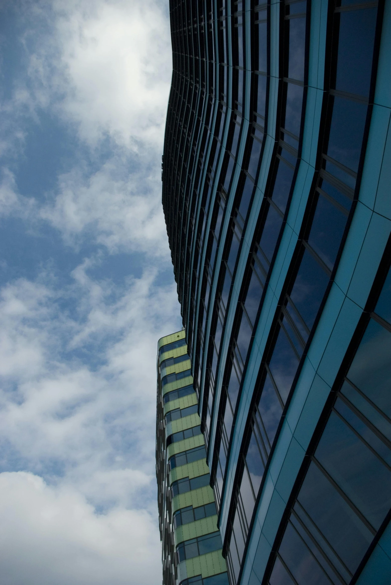 a tall building with a clock on top of it, inspired by Zaha Hadid, unsplash, reflections. shady, 8k 50mm iso 10, curves, skies