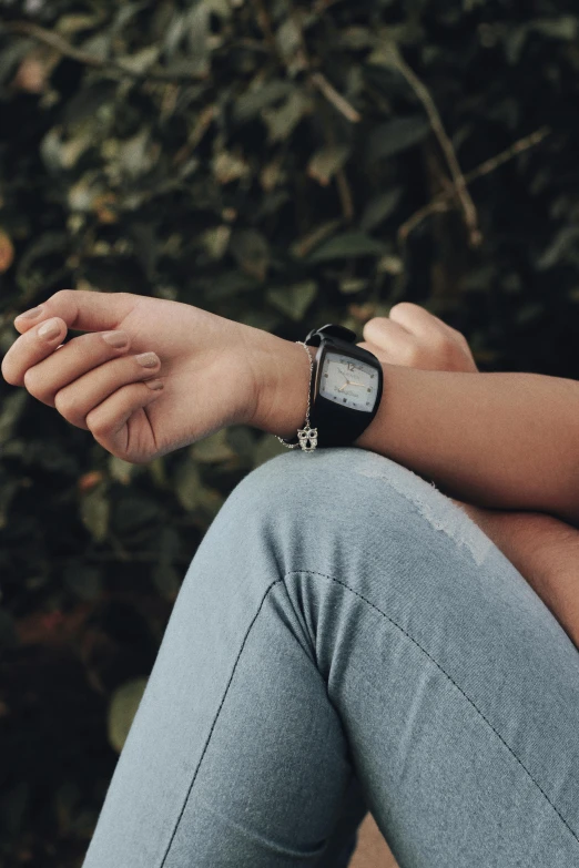 a woman sitting on a bench with a watch on her wrist, inspired by Elsa Bleda, unsplash, wearing black, synthetic bio skin, teenage boy, instagram post