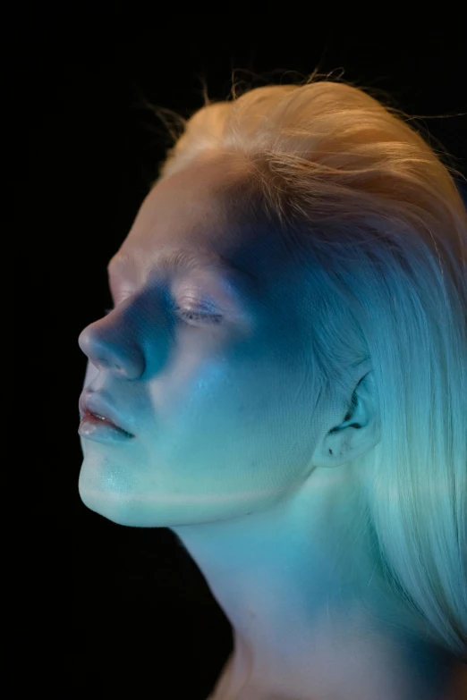 a woman with a blue light on her face, inspired by Elsa Bleda, featured on zbrush central, holography, albino skin, wax figure, avatar with a blond hair, looking off to the side