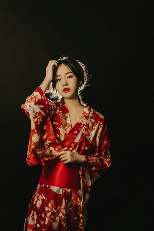a woman in a red and gold kimono, an album cover, unsplash, wearing pajamas, chengwei pan, pose 4 of 1 6, low key