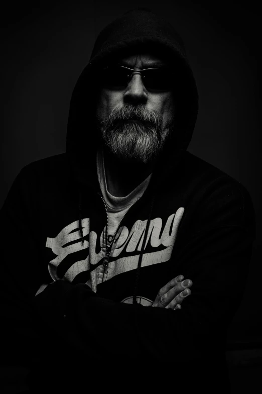 a black and white photo of a man in a hoodie, a black and white photo, unsplash, hyperrealism, white beard, biker, mark hamill, strong lighting