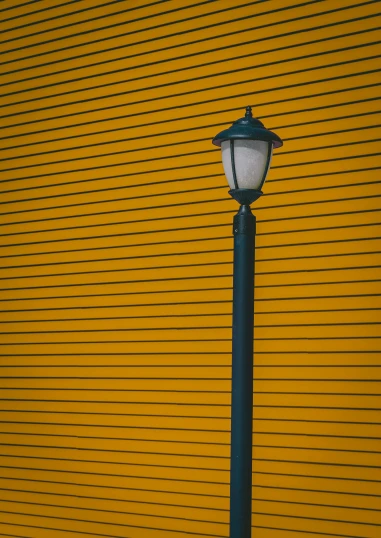 a street light in front of a yellow wall, by Carey Morris, unsplash contest winner, square lines, striped, low lights, museum light
