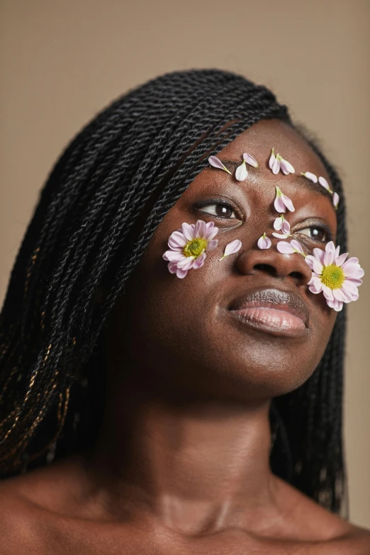 a woman with flowers on her face, by Lily Delissa Joseph, trending on pexels, black teenage girl, close - up studio photo, natural skin, taken in the early 2020s