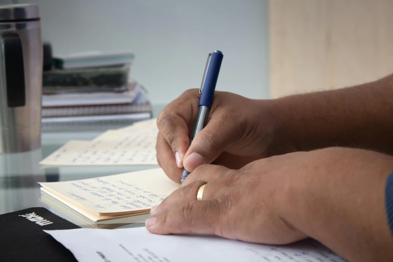 a person writing on a piece of paper with a pen, multiple stories, uploaded, rj palmer, thumbnail