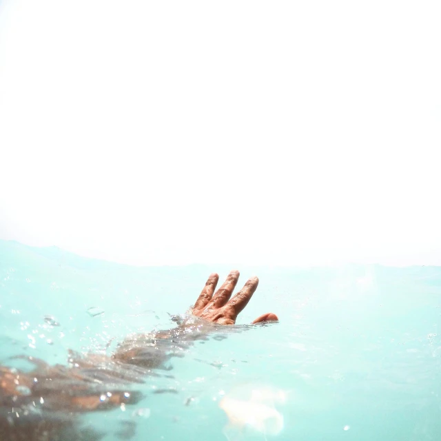 a person swimming in a body of water, an album cover, pexels, empty hands, emergency, light blue water, murder