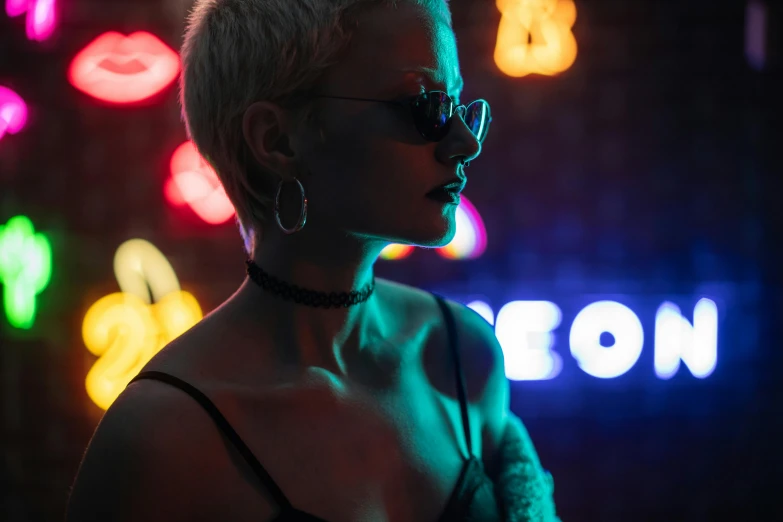a woman standing in front of a neon sign, inspired by Elsa Bleda, pexels contest winner, holography, girl with short white hair, in a strip club, wearing black rimmed glasses, a woman's profile