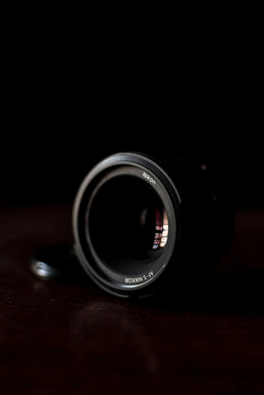 a close up of a camera lens on a table, by Tom Bonson, sony 1 7 5 mm, shot on sony a 7, 33mm photo, f / 1. 2