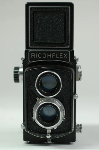 a close up of a camera on a white surface, rolleiflex, a pair of ribbed, [32k hd]^10, rice