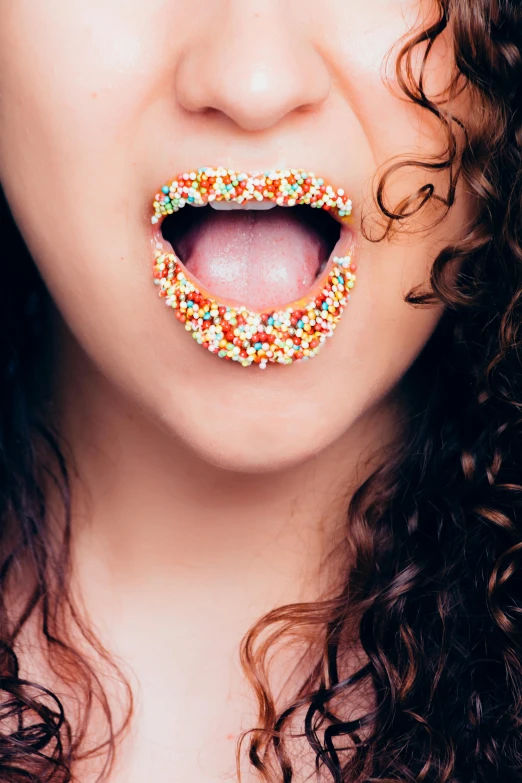 a close up of a person with a doughnut in their mouth, inspired by Bert Stern, trending on pexels, pointillism, curls, marshmallow, sexy lips, multicoloured