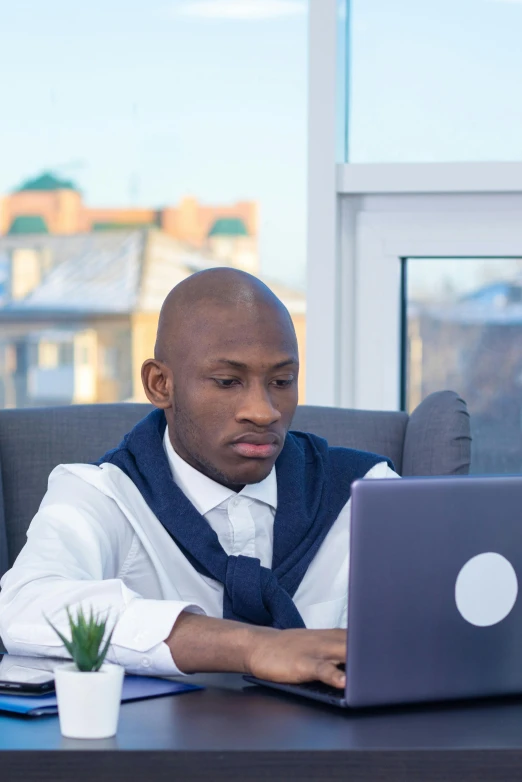 a man sitting at a desk using a laptop computer, atiba jefferson, thumbnail, gilleard james, looking content