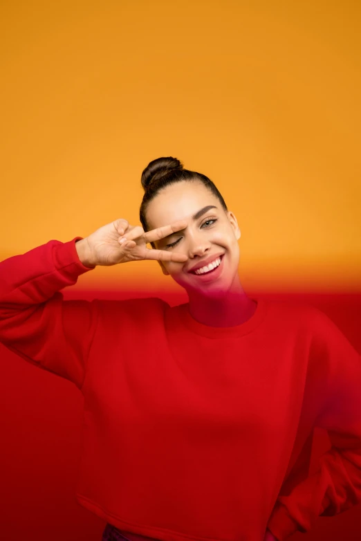 a woman covering her eyes with her hands, a picture, trending on pexels, minimalism, with red haze and a massive grin, gal gadot and tribbles, red+yellow colours, topknot
