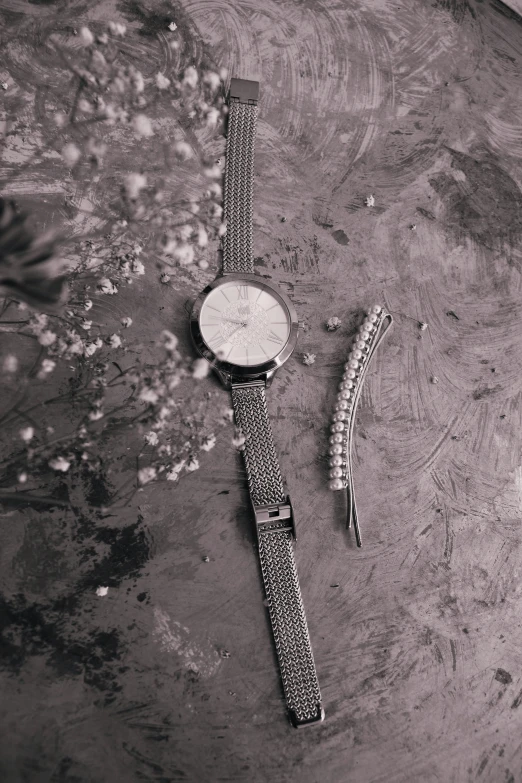 a couple of watches sitting on top of a table, a black and white photo, under construction, with sparkling gems on top, vsco film grain, killua zoldyck made of jewlery