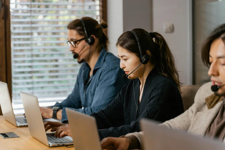 a group of people sitting at a table with laptops, trending on pexels, wearing a headset, te pae, thumbnail, high quality image