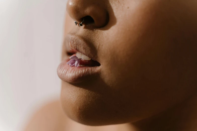 a close up of a person with a nose piercing, large tongue, profile image