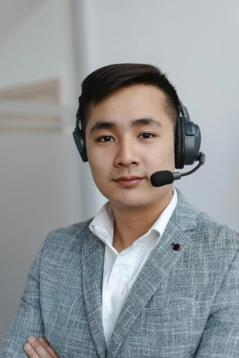 a man wearing a headset with his arms crossed, a portrait, reddit, mai anh tran, professional profile photo, wearing headset, ja mong