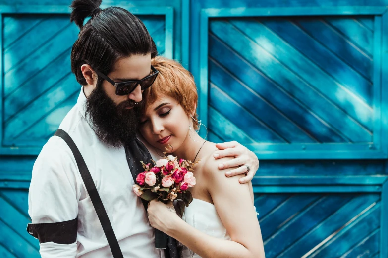 a man and a woman standing next to each other, a photo, pexels contest winner, neo-romanticism, bearded and built, bouquet, blue themed, square