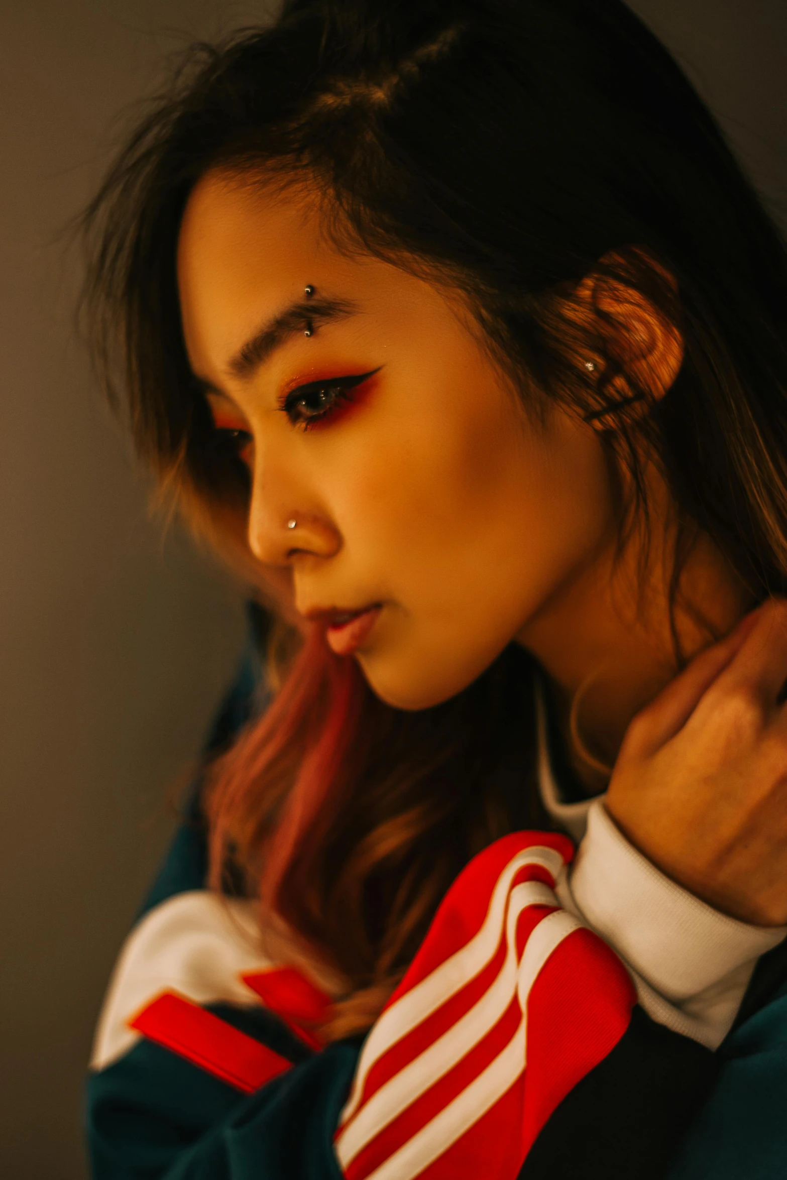 a woman with a tie around her neck, inspired by Zhu Da, trending on pexels, hyperrealism, wearing a red hoodie, soft lighting from above, of taiwanese girl with tattoos, glamor profile pose