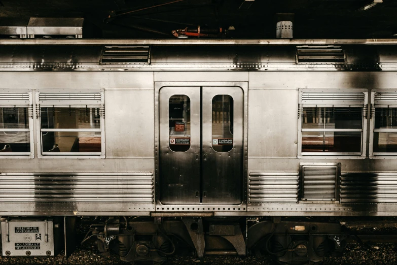 a silver train sitting on top of a train track, by Elsa Bleda, in a subway, 🚿🗝📝, on black background, new jersey