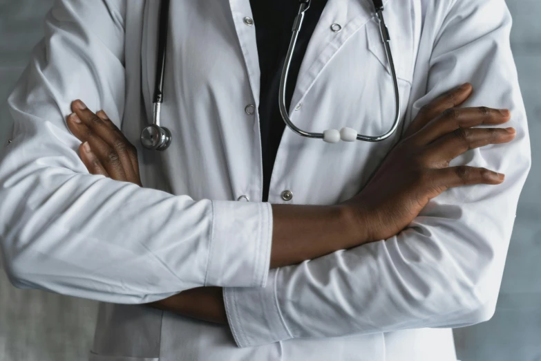 a close up of a person with a stethoscope, trending on pexels, hurufiyya, folded arms, lgbtq, white uniform, man is with black skin