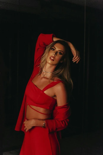 a woman in a red dress posing for a picture, an album cover, inspired by Elsa Bleda, trending on pexels, wearing a sexy cropped top, katey truhn, late night, uncropped