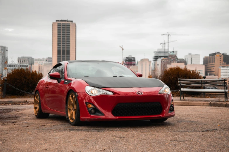 a red sports car parked in a parking lot, by Jason Felix, pexels contest winner, renaissance, red gold black, 2013 scion tc, 2 5 6 x 2 5 6, on a street race track