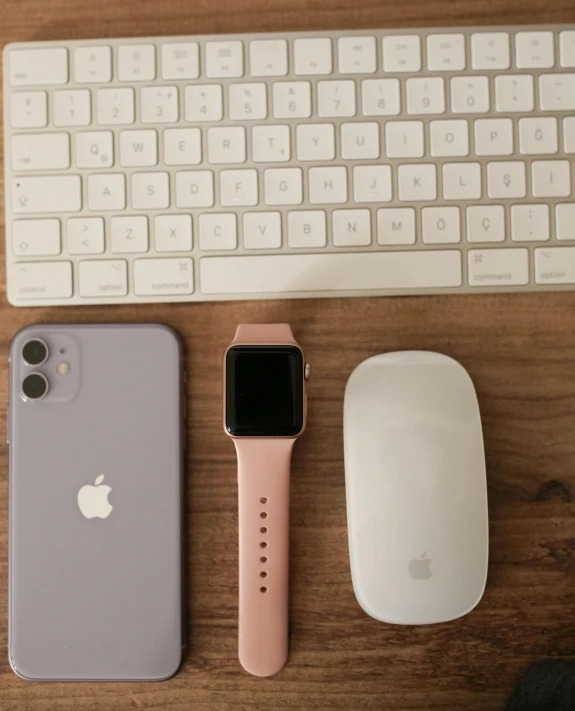 an apple watch sitting next to a keyboard and a mouse, a picture, iphone photo, ((pink)), product image