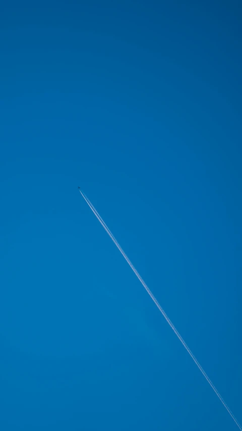 a large jetliner flying through a blue sky, by Peter Churcher, postminimalism, thumbnail, rocket, aerial footage, single long stick