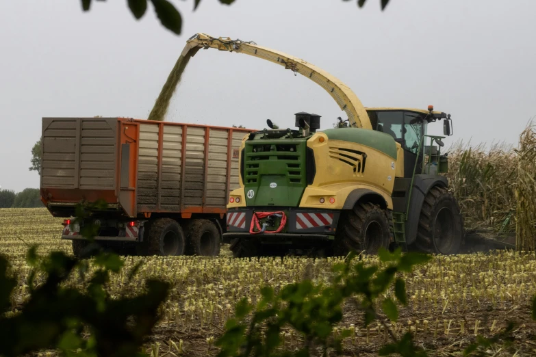 a tractor that is sitting in the grass, by Schelte a Bolswert, organic biomass, yellow and green, stålenhag, heavy grain-s 150