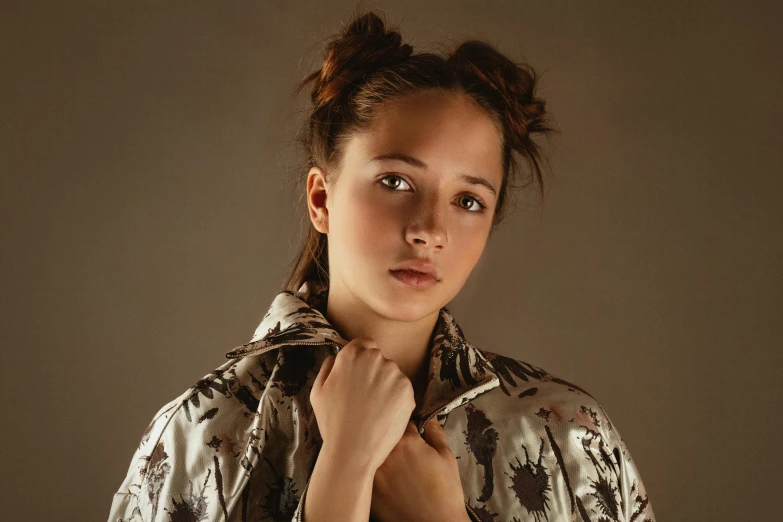 a close up of a person wearing a jacket, inspired by Anna Füssli, trending on pexels, hyperrealism, brown hair in two buns, a beautiful teen-aged girl, studio lighting”, patterned clothing