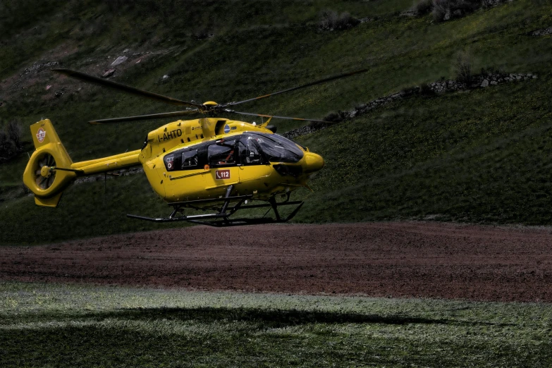 a yellow helicopter flying over a lush green hillside, pexels contest winner, figuration libre, medical, flying mud, vray 4k, grey