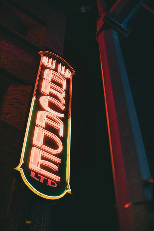 a neon sign hanging from the side of a building, by Bernie D’Andrea, trending on pexels, verdadism, brocade, an old cinema, weenie, middle of the night