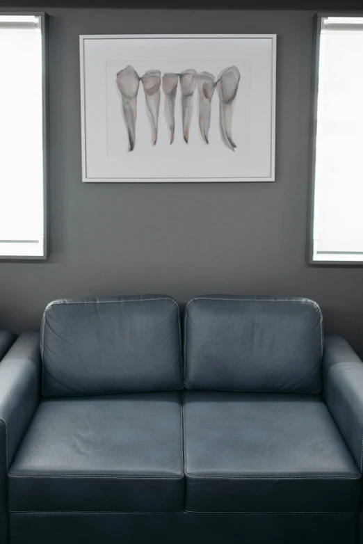 a couch sitting in a living room next to two windows, inspired by Henry Moore, doctors office, gray background, soft vinyl, male and female