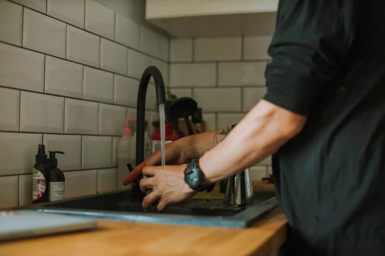 a man washing his hands in a kitchen sink, pexels contest winner, fan favorite, water pipe, sydney hanson, profile image